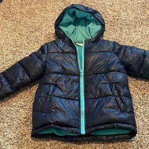 Navy and turquoise puffer jacket gently used